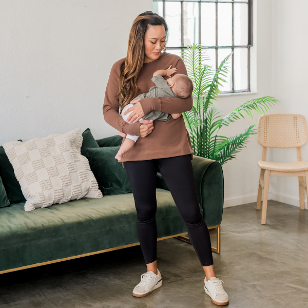 Mom nursing her baby in a brown breastfeeding yoga tunic with hidden zipper access
