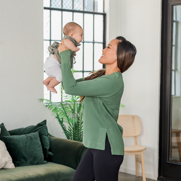 Mom wearing a green nursing yoga tunic sweatshirt