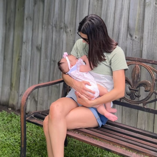 Mom nursing her baby in a green shirt