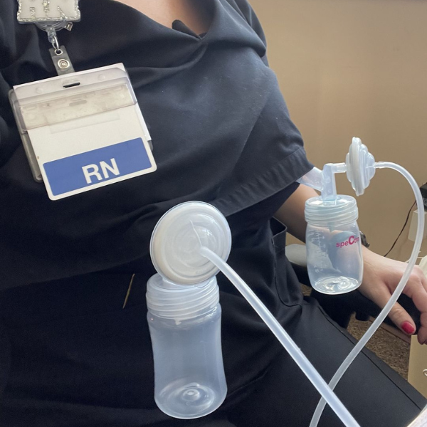 Mom pumping breastmilk in scrubs