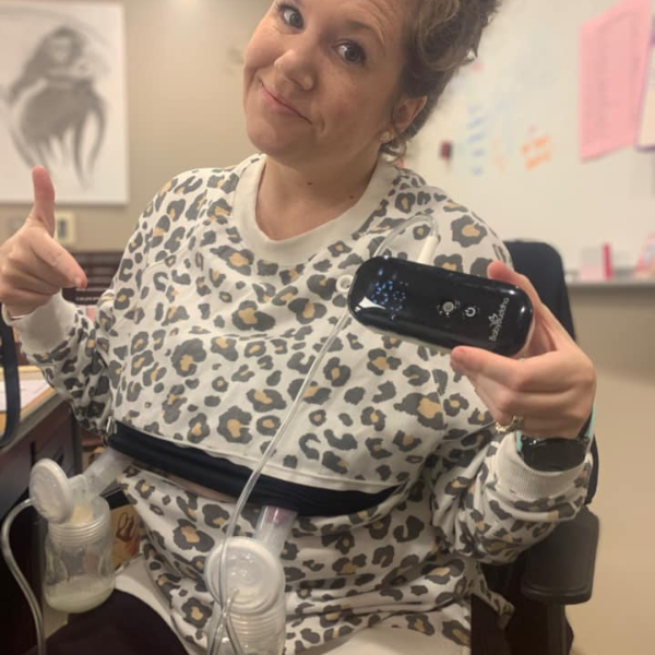 Mom wearing a cream leopard nursing sweatshirt for pumping