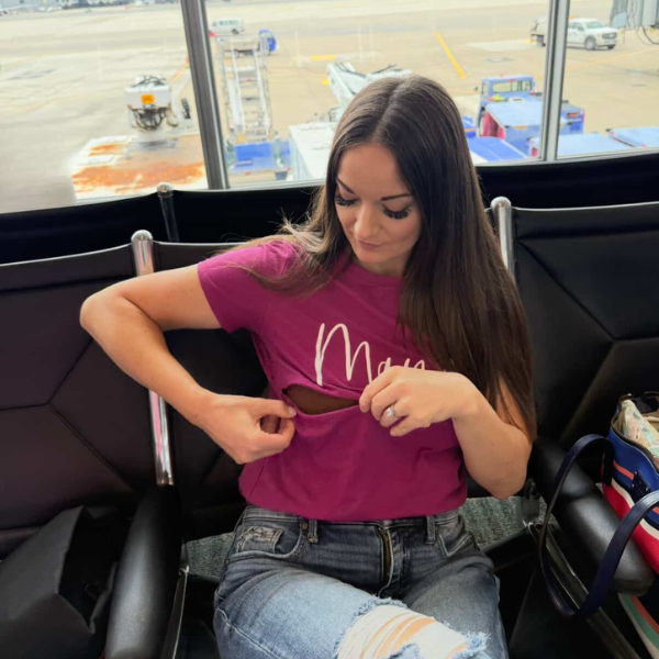 Mom wearing a nursing shirt while traveling for easy breastfeeding access