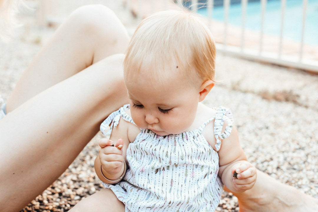 baby with mom by a pool