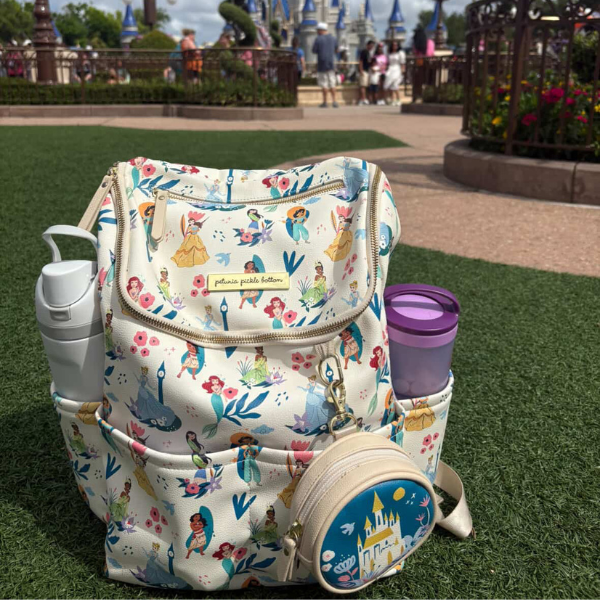 Disney diaper bag packed with breastfeeding and pumping essentials including portable fan, breast pads, snacks, pump wipes, portable charger, and baby supplies.