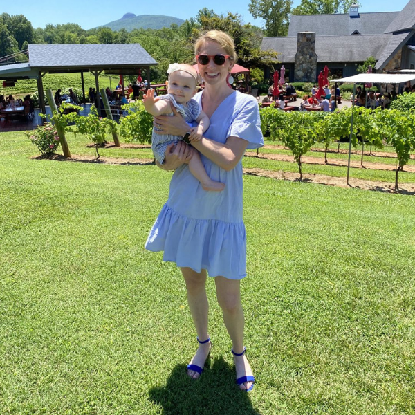 Mom wearing a cotton nursing dress with hidden breastfeeding access for the summer