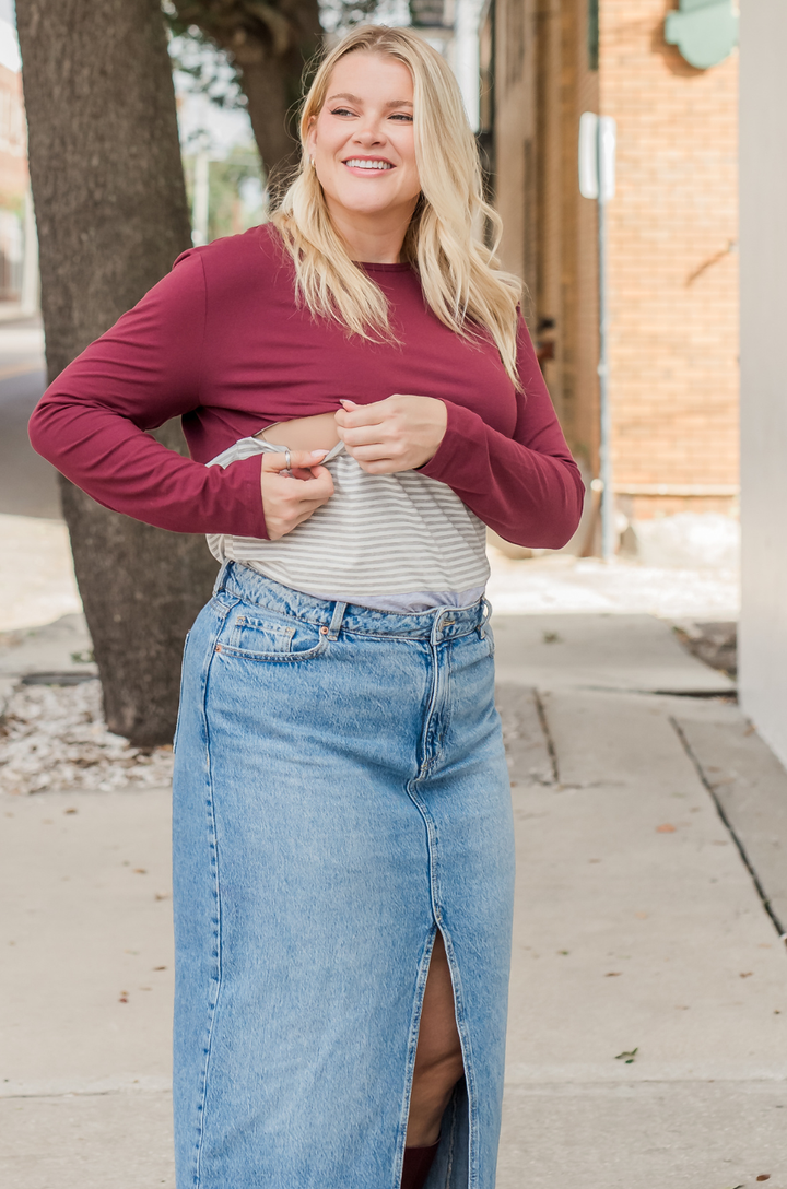 The long sleeve wine stripe colorblock breastfeeding top is styled casually with a jean skirt for everyday wear.