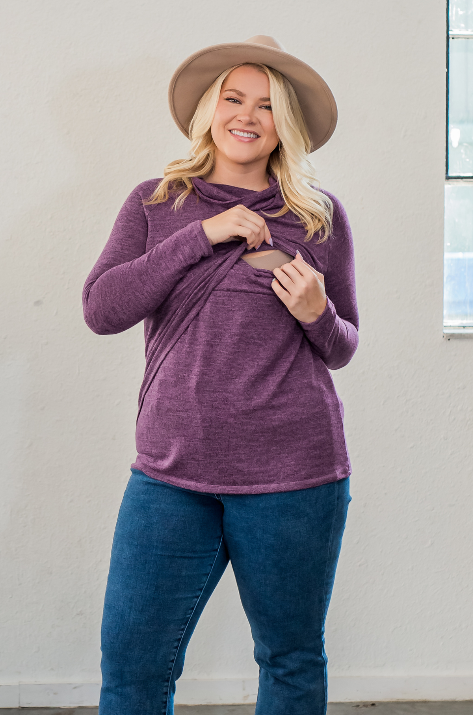 Woman wearing asymmetrical purple sweater for nursing