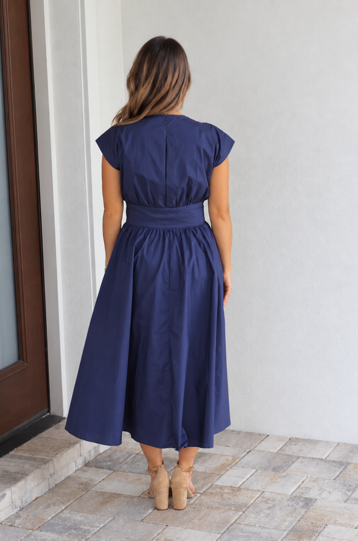 back view of a nursing mom wearing a cotton blue breastfeeding dress