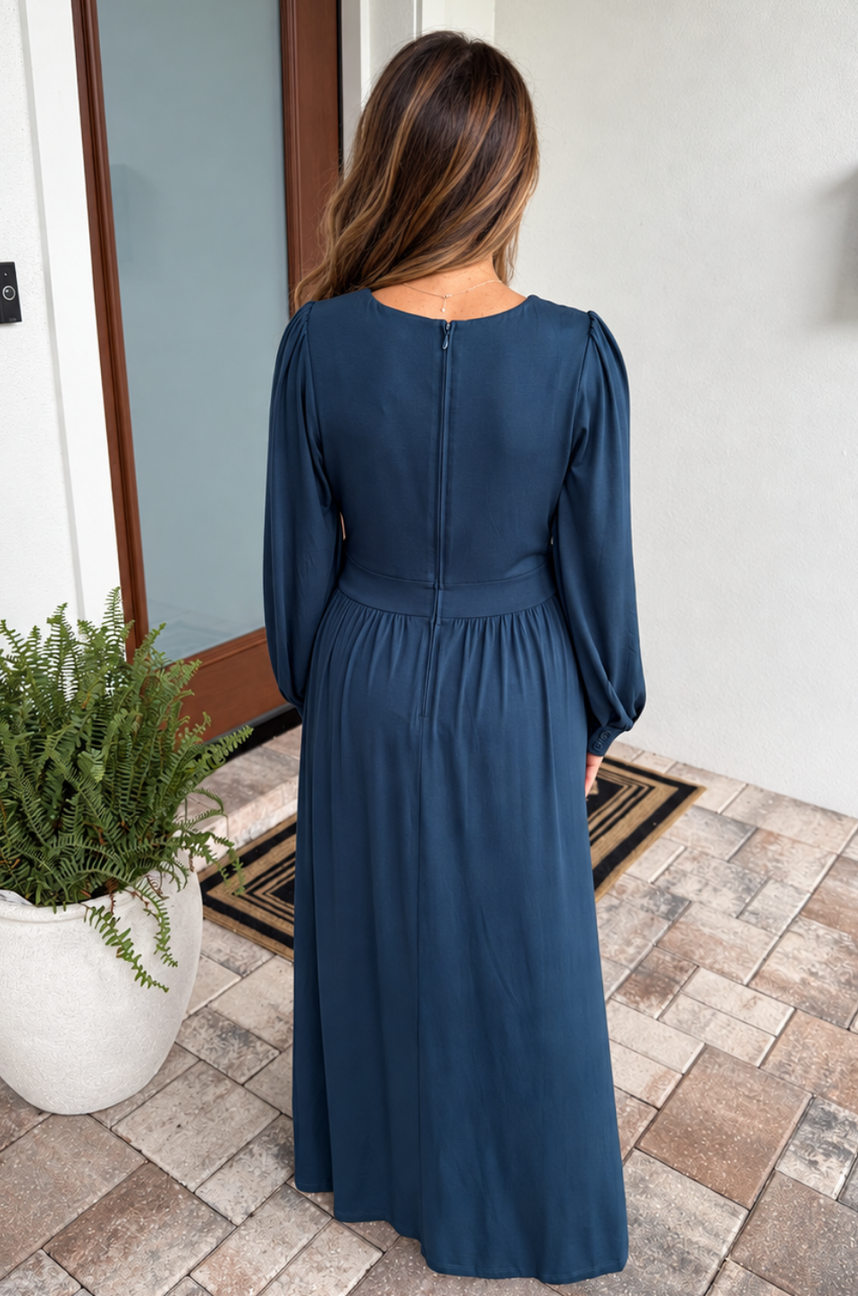 Back view of a mom wearing a nursing dress for pumping and nursing. This dress works for both maternity and postpartum days. 