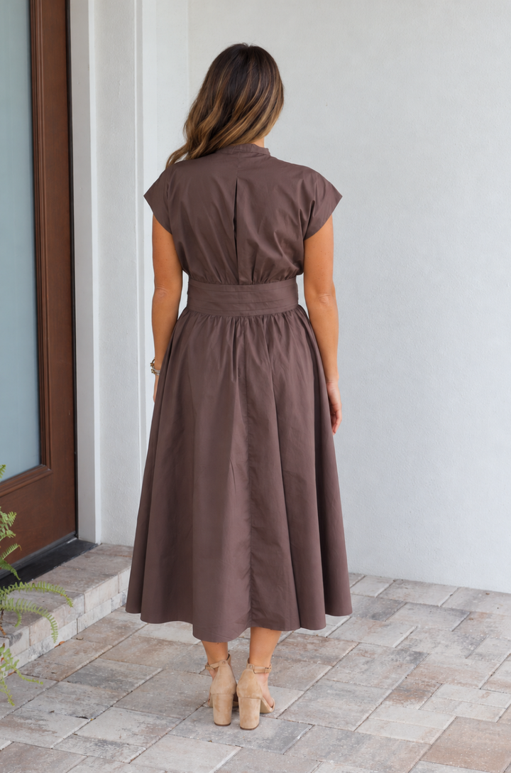 Back view of a brown cotton nursing dress worn by a breastfeeding mom