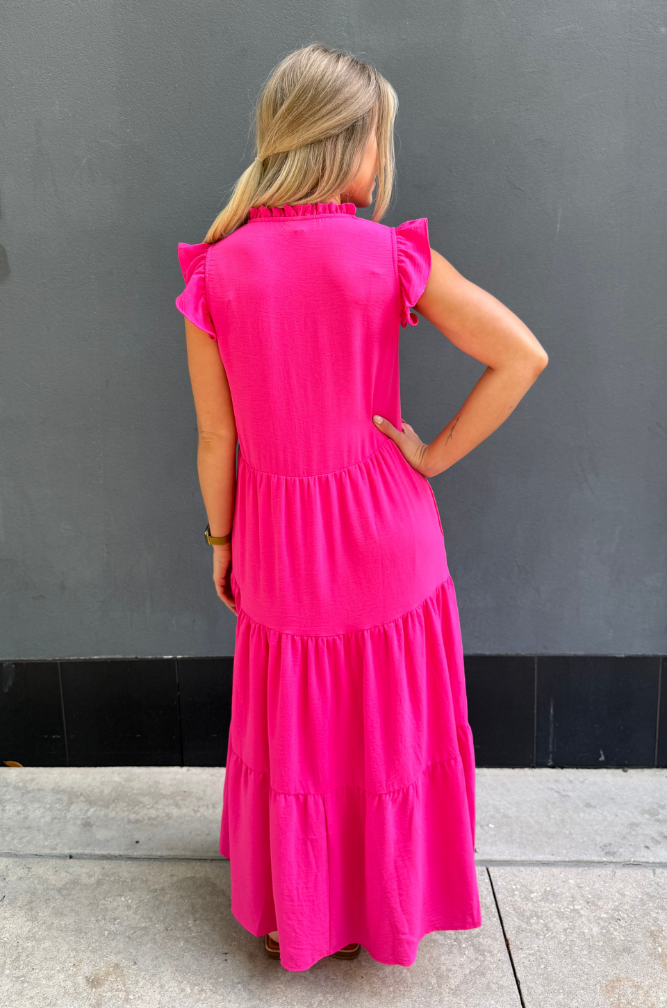 Woman in pink tiered nursing dress with hidden zippers for breastfeeding, lightweight fabric and comfortable everyday style