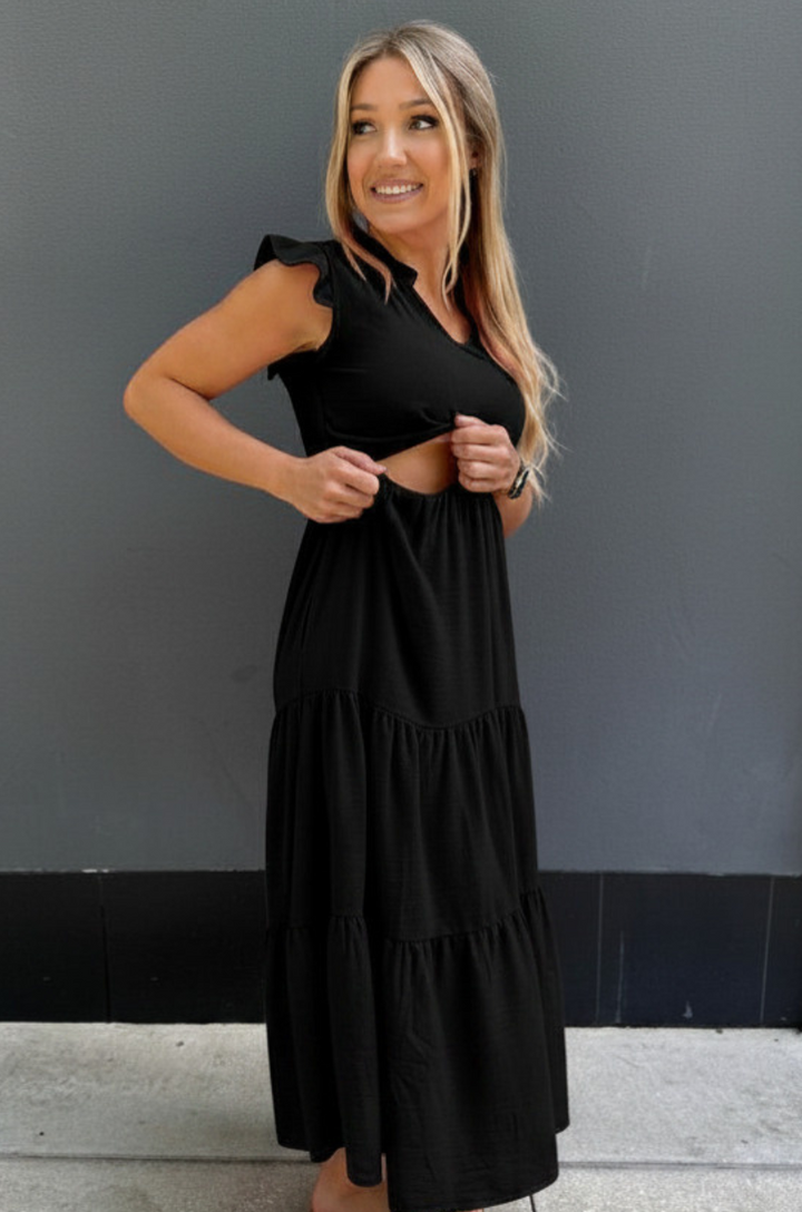 Mom showing the hidden nursing access in a black tiered breastfeeding dress for summer