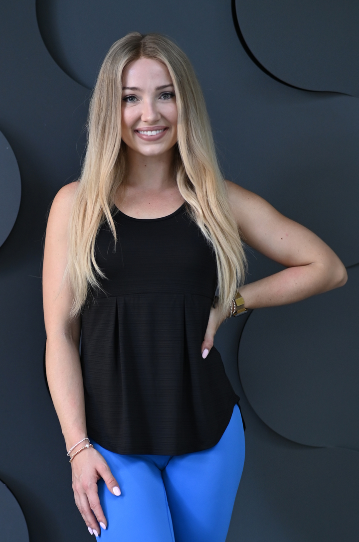 Front view of a black breastfeeding workout tank top with hidden zipper breastfeeding access, moisture-wicking athletic fabric, and a flattering sleeveless fit designed for active breastfeeding moms.
