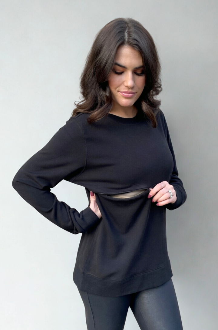 The hidden zipper breastfeeding access on this black crewneck sweatshirt is shown partially open to demonstrate functional design.
