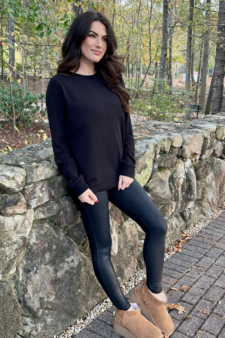 The black crewneck breastfeeding sweatshirt is shown from the front with a relaxed, cozy fit perfect for postpartum wear.