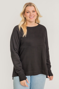 Woman wearing a breastfeeding nursing tunic with hidden access for pumping and nursing