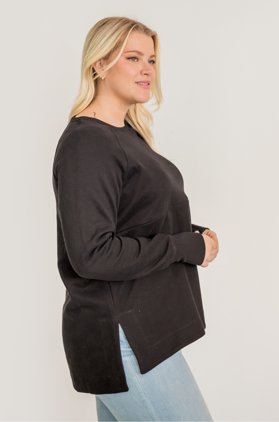 Woman wearing a black yoga nursing tunic