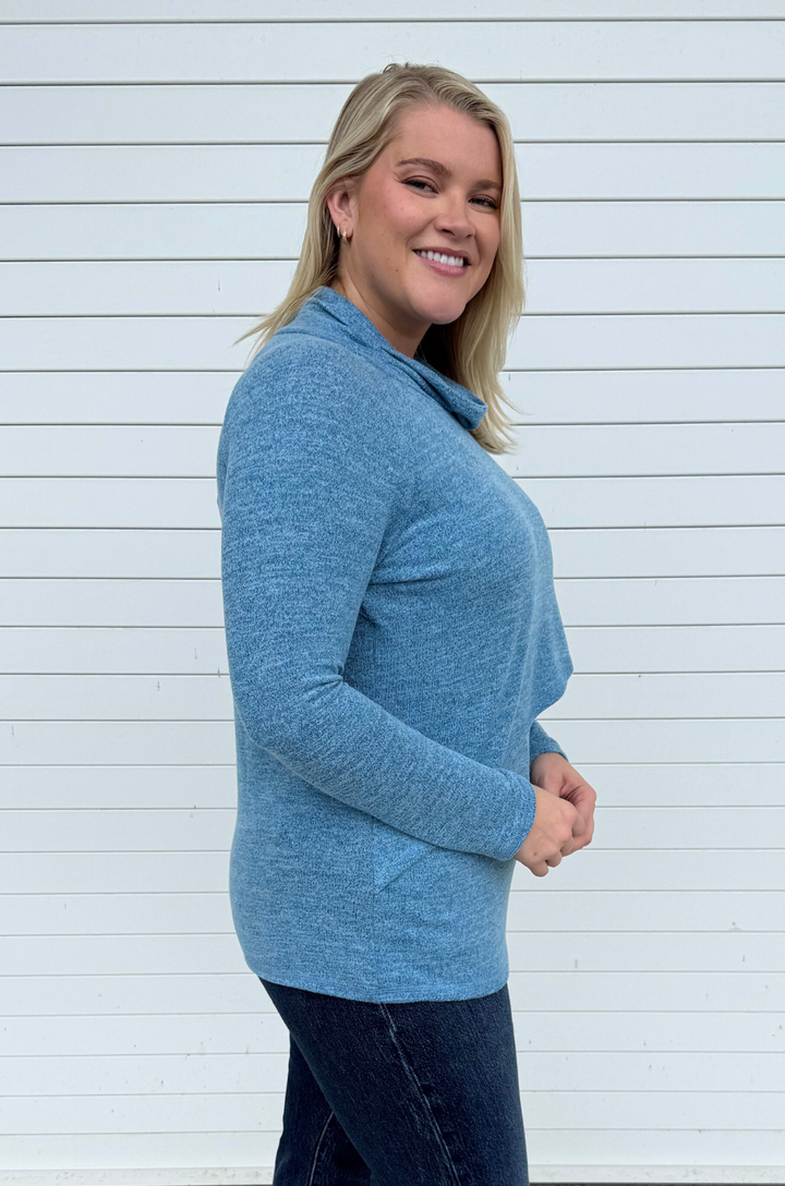 Side view of asymmetrical breastfeeding sweater showing layered front flap that allows breastfeeding access.