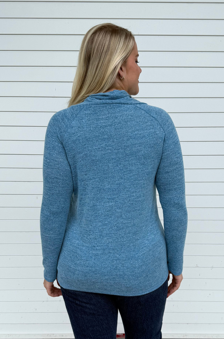 Back view of blue breastfeeding sweater with smooth back and asymmetrical hem.