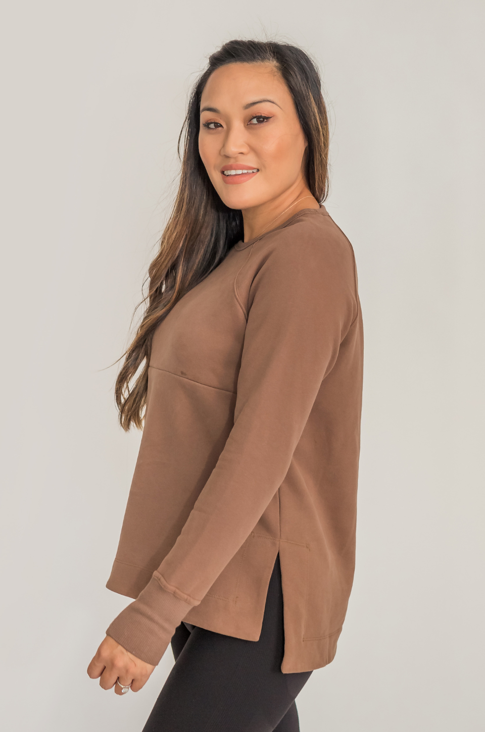 Woman wearing a brown long-sleeve top for nursing