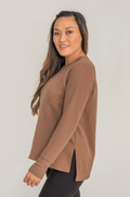 Woman wearing a brown long-sleeve top for nursing
