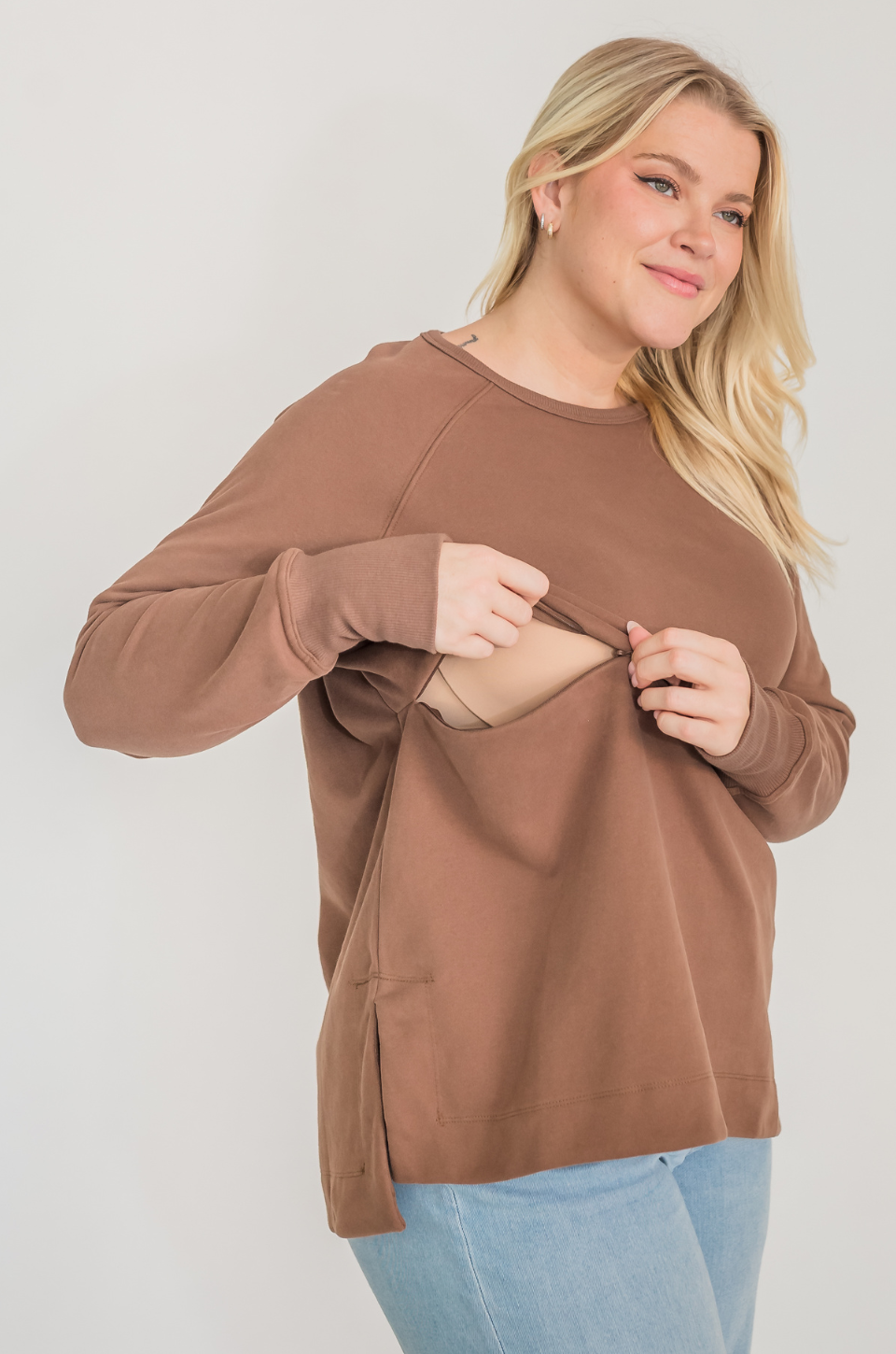 Mom wearing brown nursing tunic with hidden breastfeeding access 