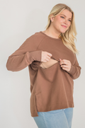 Mom wearing brown nursing tunic with hidden breastfeeding access 