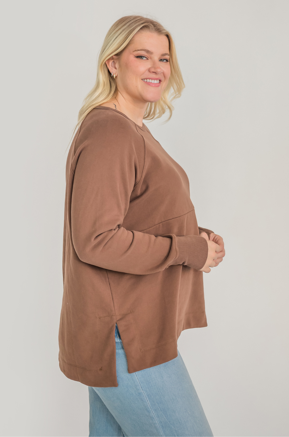 Mom wearing brown breastfeeding tunic with hidden zipper access for pumping and nursing