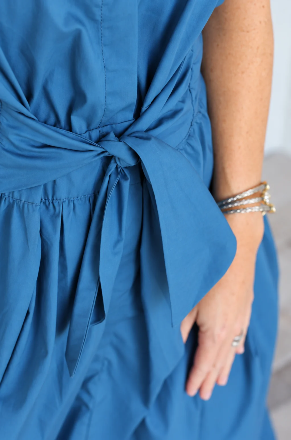 Close up of a bow on a cotton nursing dress with hidden breastfeeding access