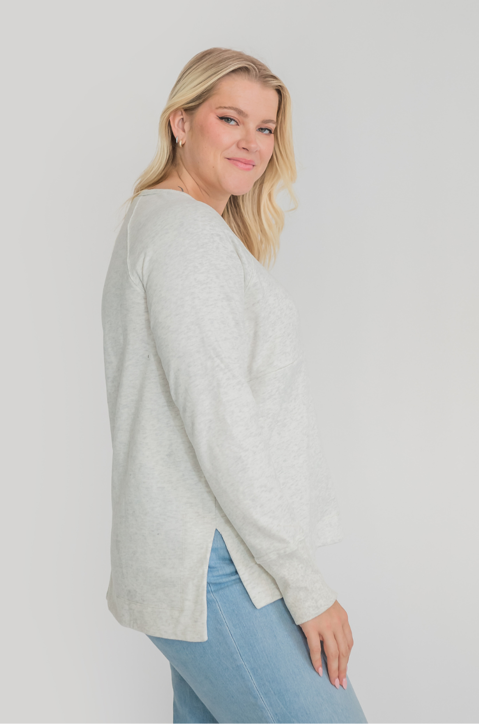 Woman in blue jeans and breastfeeding shirt