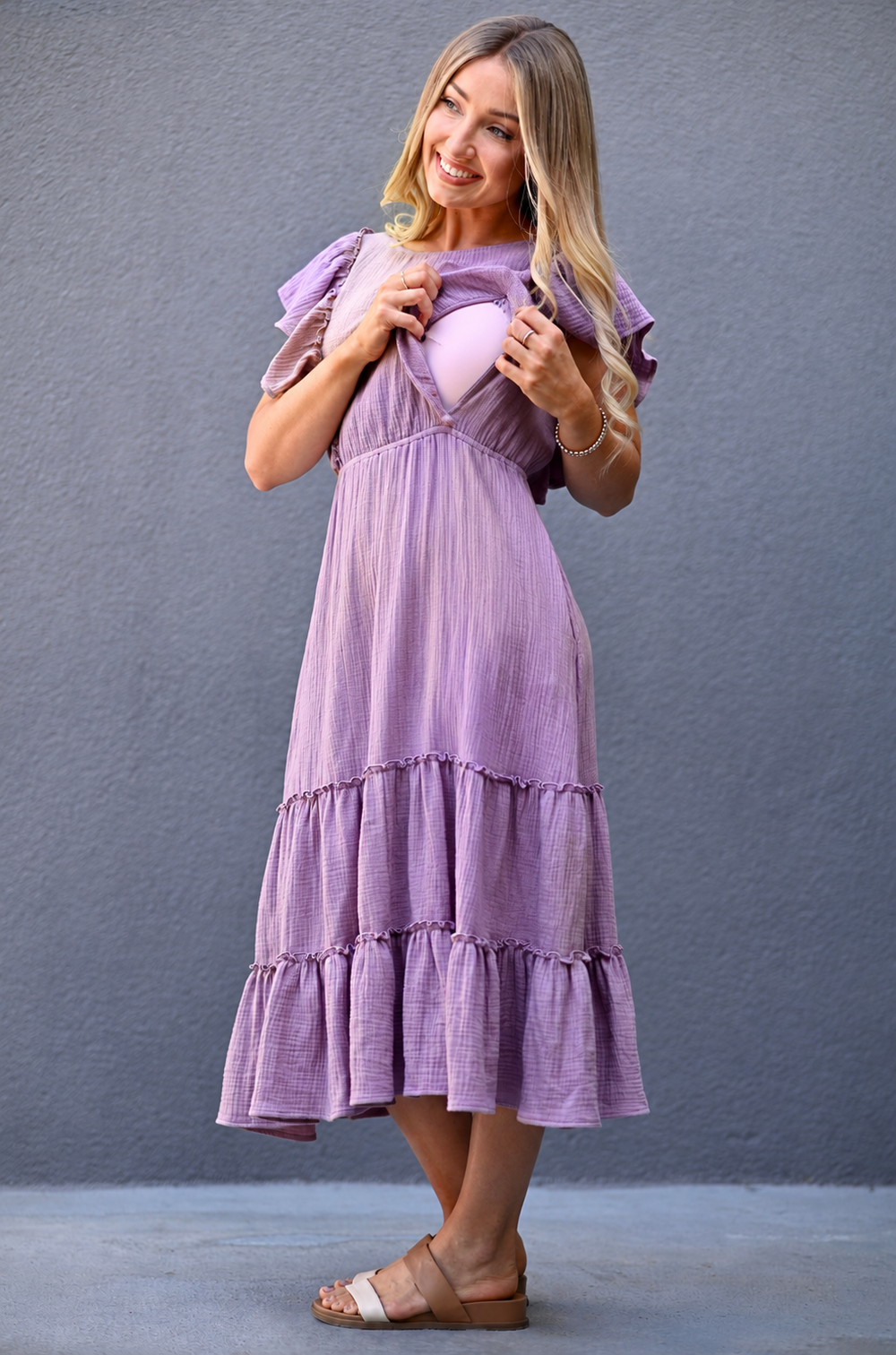 Close view of hidden zipper nursing access behind ruffles on lavender gauze midi dress designed for breastfeeding.