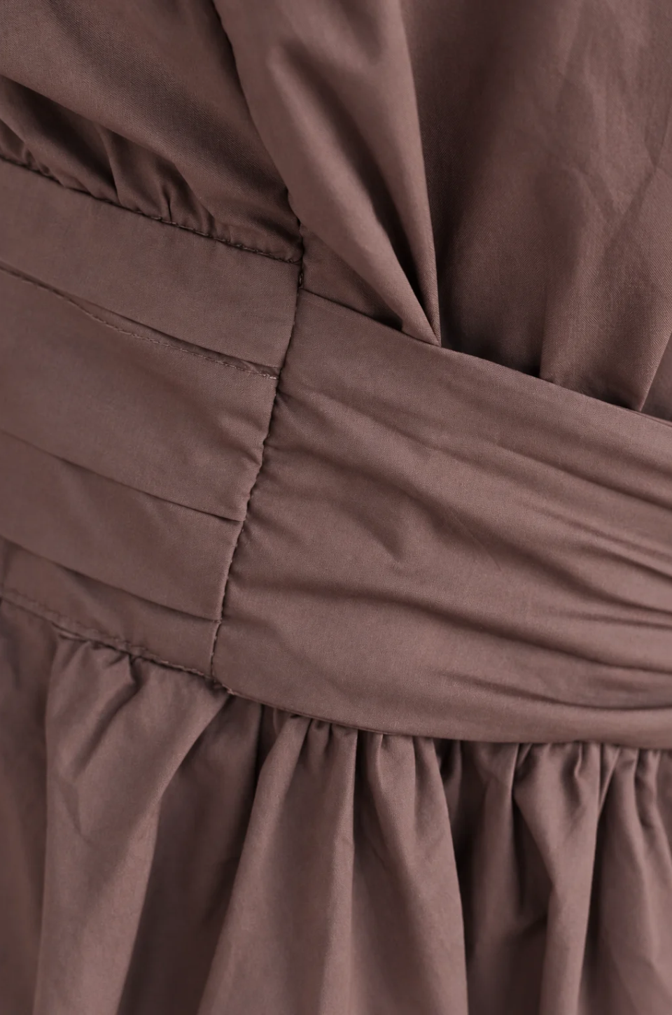 Close up of faux belt on brown cotton nursing dress
