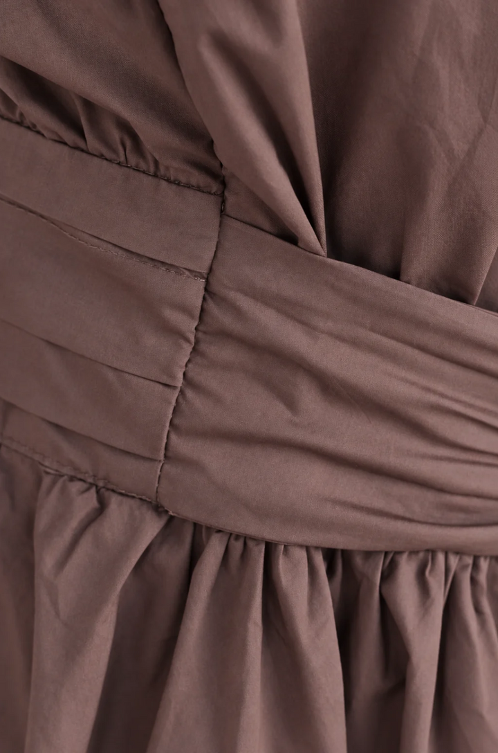 Close up of faux belt on brown cotton nursing dress