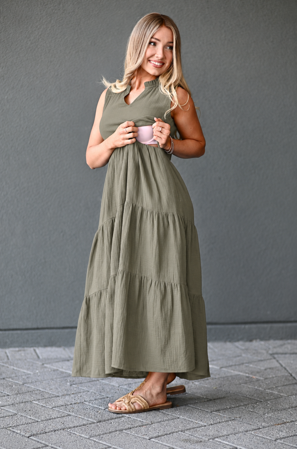 Woman showing how nursing access works in a cotton gauze breastfeeding dress