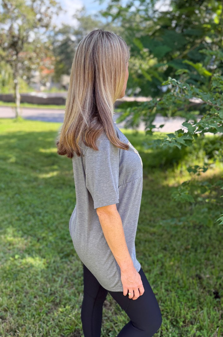 A side view shows a mom wearing the Nashville nursing graphic gray t-shirt with leggings, emphasizing comfortable movement and everyday wear.