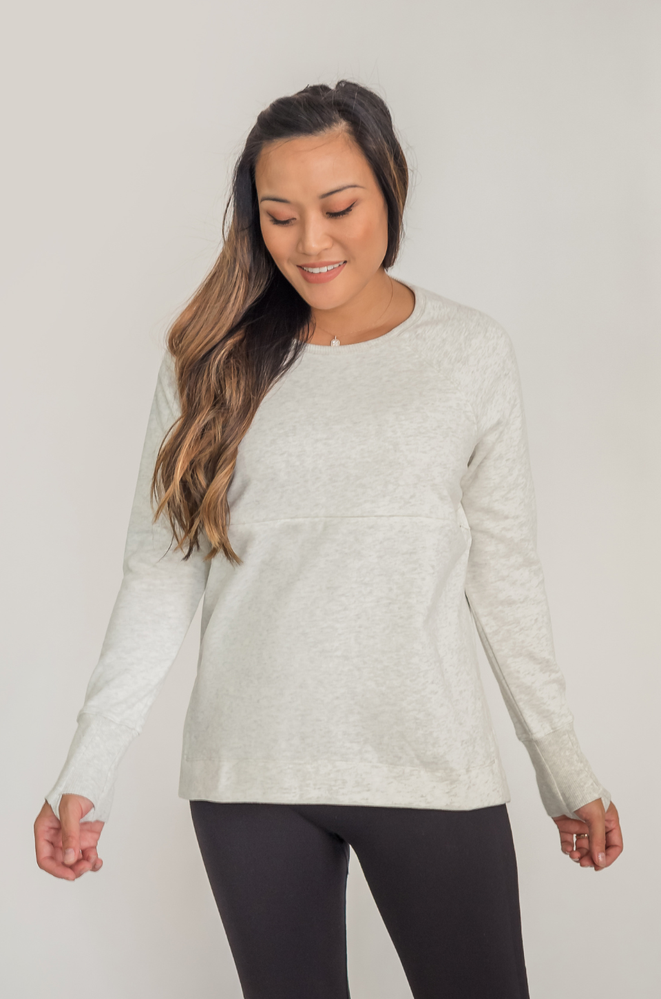 Mom wearing a light gray nursing tunic 