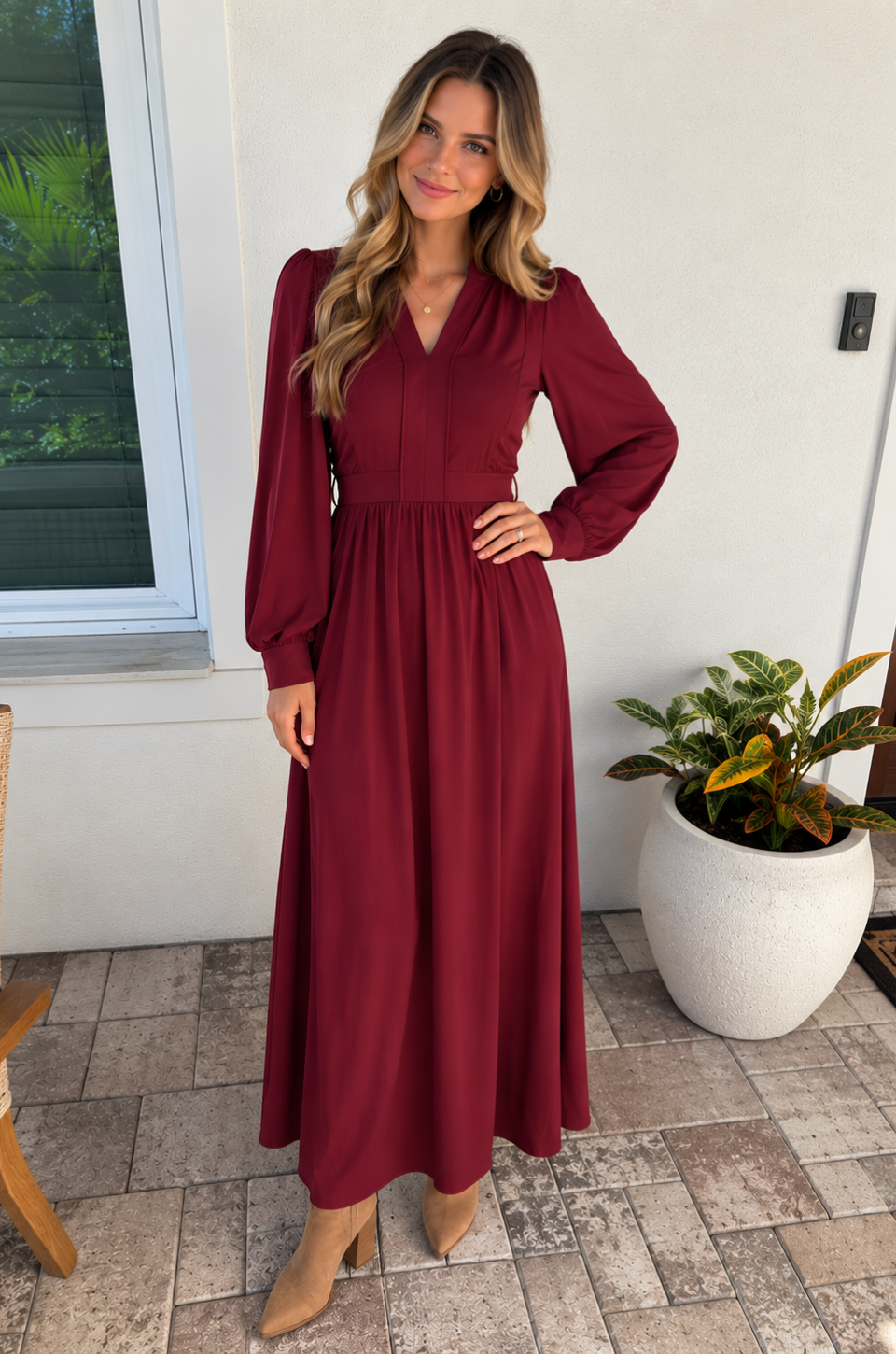 Mom wearing a deep red nursing dress with hidden breastfeeding access standing on a front porch for fall