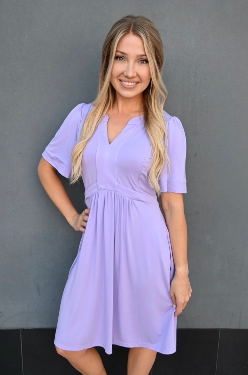 Breastfeeding mom wearing lilac short sleeve nursing dress with hidden zipper access, flattering postpartum fit, and pockets by Nursing Queen
