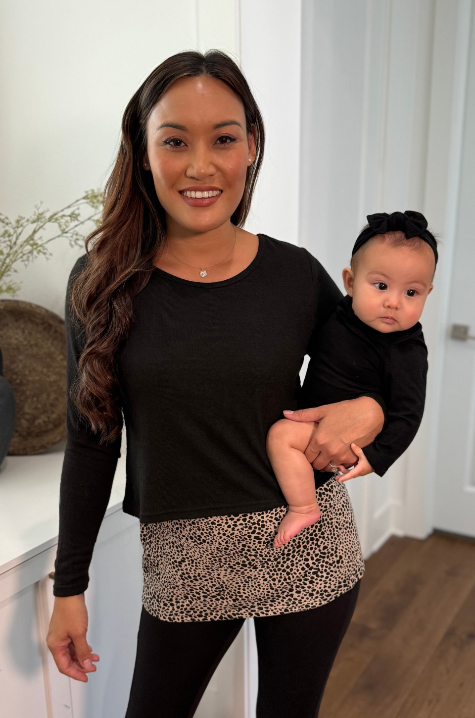 Mom wearing nursing sweater with lift-up flap access