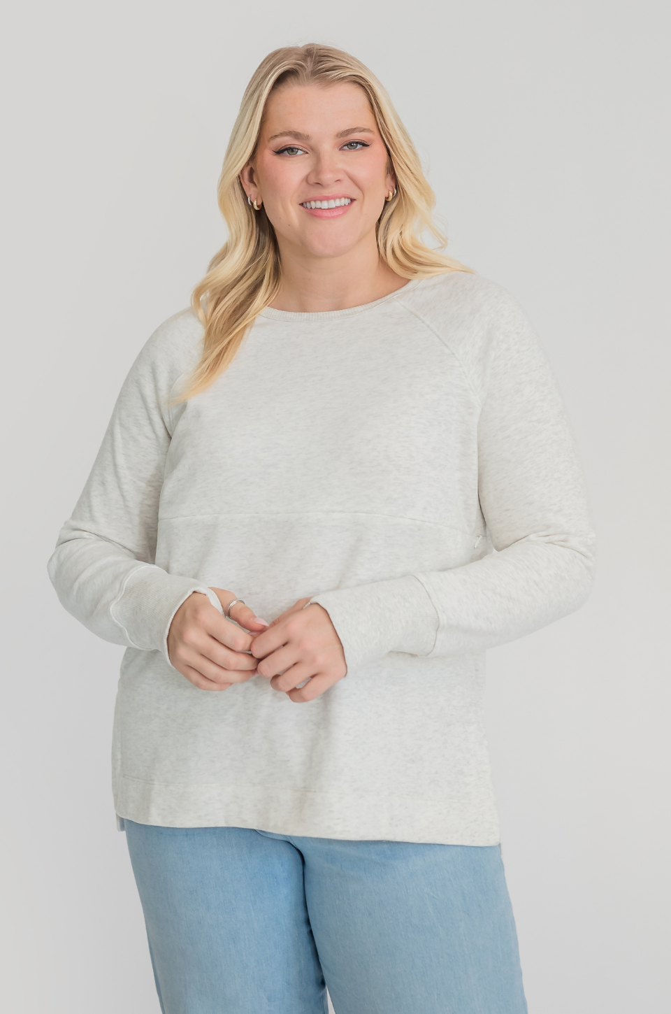 Woman wearing a light gray nursing tunic