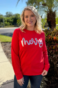 Woman wearing a Merry nursing shirt that's red