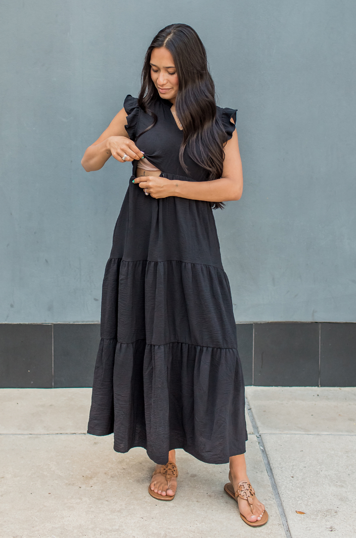 Mom showing the hidden nursing access on a black breastfeeding dress for summer