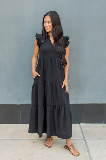 Mom wearing a black nursing dress with pockets
