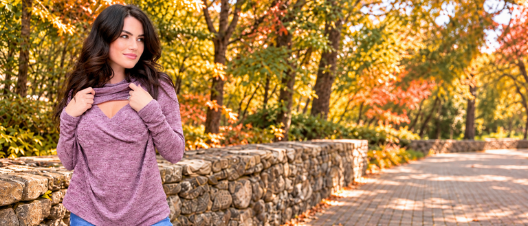 Mom wearing a purple sweater for nursing showing the breastfeeding access