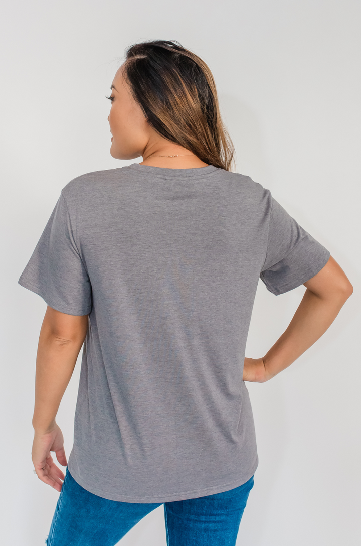 A back view shows a mom wearing the Nashville nursing graphic gray t-shirt with full coverage and a relaxed silhouette.