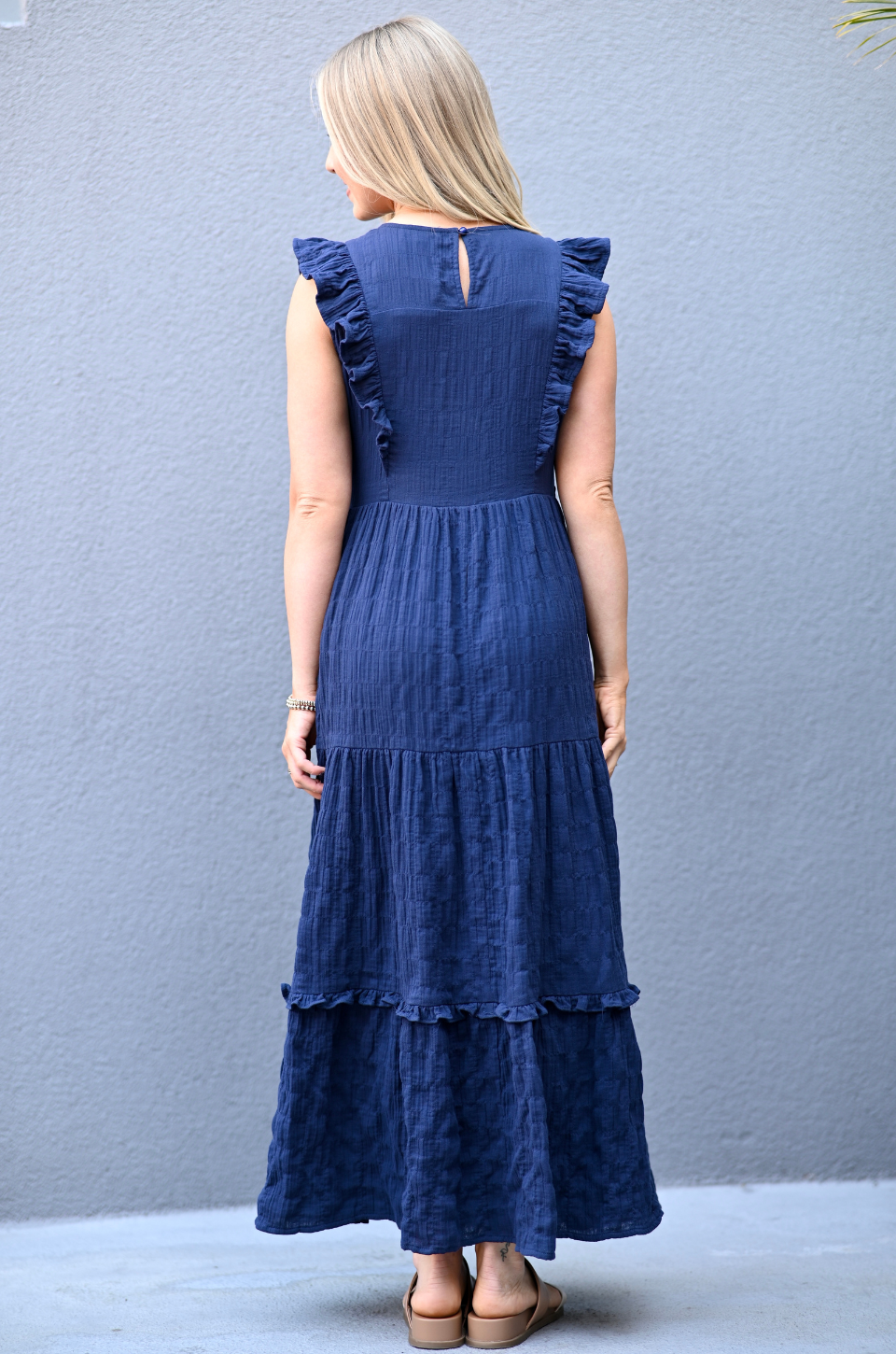 Back view of a woman wearing a Navy cotton nursing dress