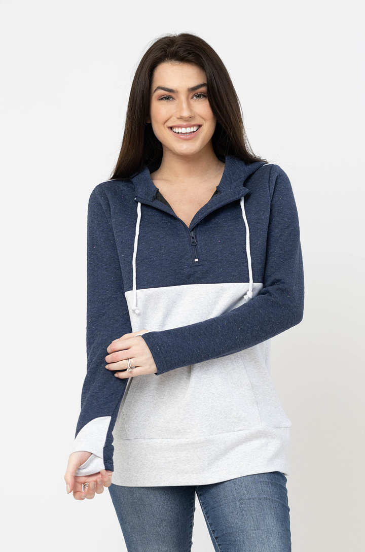 Front view of blue waffle breastfeeding hoodie worn by a mom, showing thumbhole sleeves and quarter-zip neckline with concealed zipper nursing access.