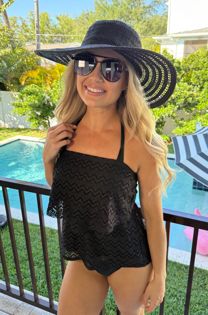 Mom wearing a nursing tankini with hidden breastfeeding access