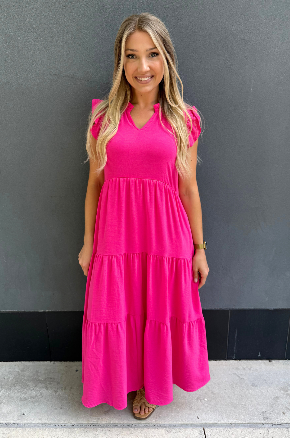 Breastfeeding mom wearing pink tiered nursing midi dress with ruffle sleeves and hidden zipper access for easy nursing and pumping