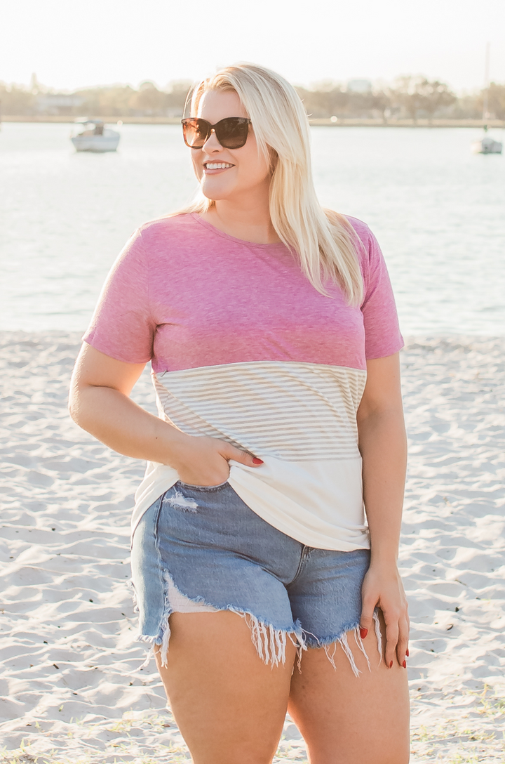The pink and white 3-block colorblock breastfeeding t-shirt is shown from the front on a woman with a comfortable and flattering fit.